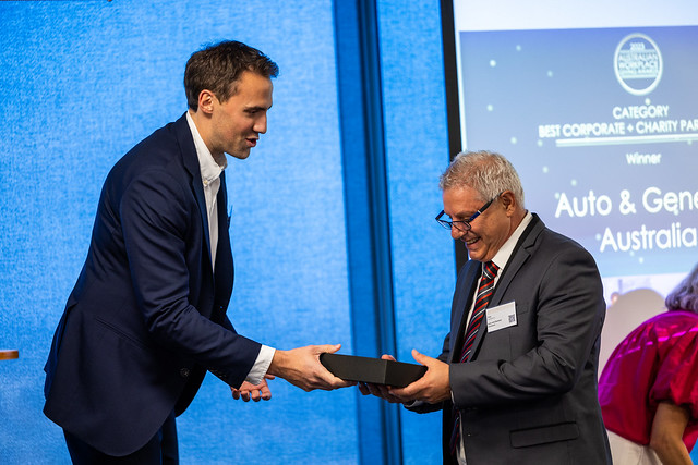 Australian Workplace Giving Award winner receiving trophy